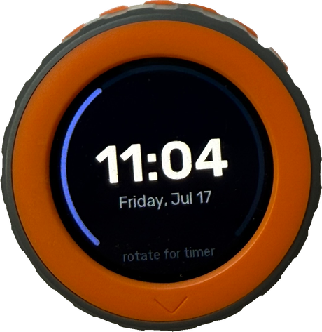 M5Stack Dial idle clock page: 11:04, Friday Jul 17, a thin seconds ring and the rotate for timer hint