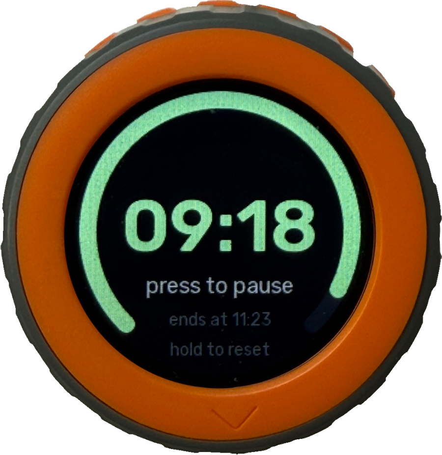 M5Stack Dial running the ESPHome kitchen timer: green arc, 09:18 remaining, press to pause, ends at 11:23 and hold to reset on the round display