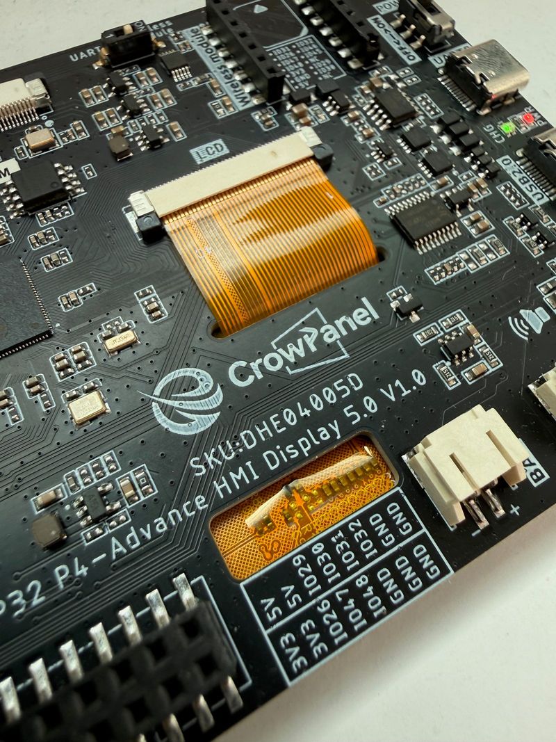 Back of the CrowPanel Advance 5.0 ESP32-P4 showing the wireless module socket, DIP switch, GPIO header and battery connector