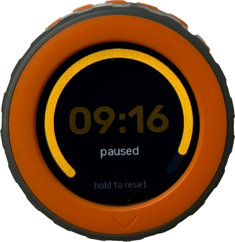 M5Stack Dial timer paused: 09:16 in amber with the arc frozen, paused, hold to reset