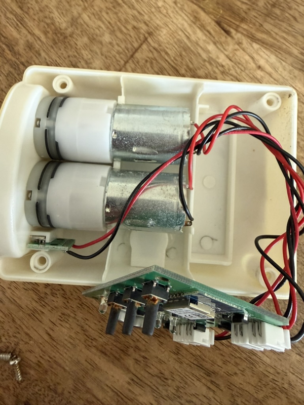 Guan Sen irrigation controller opened up showing the two small 12V pumps mounted inside
